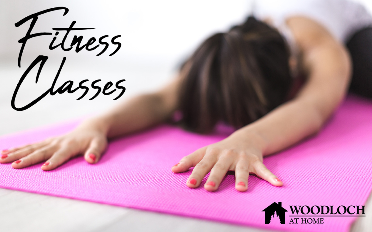 Woman doing yoga stretch on a mat. Text: Fitness Classes, Woodloch at Home.