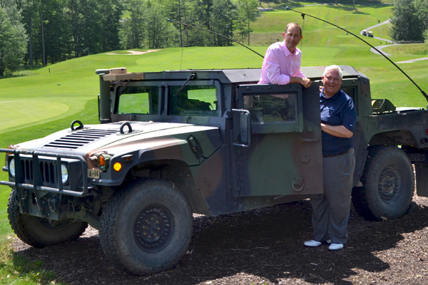 Folds of Honor participants next to military humvee