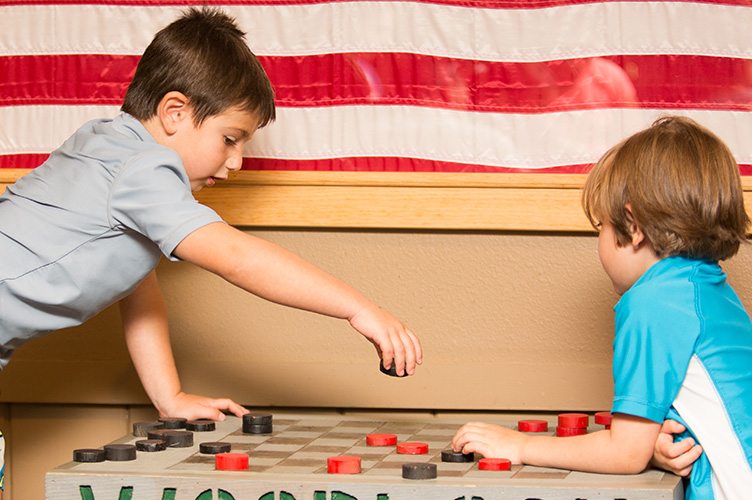 Two boys playing checkers.