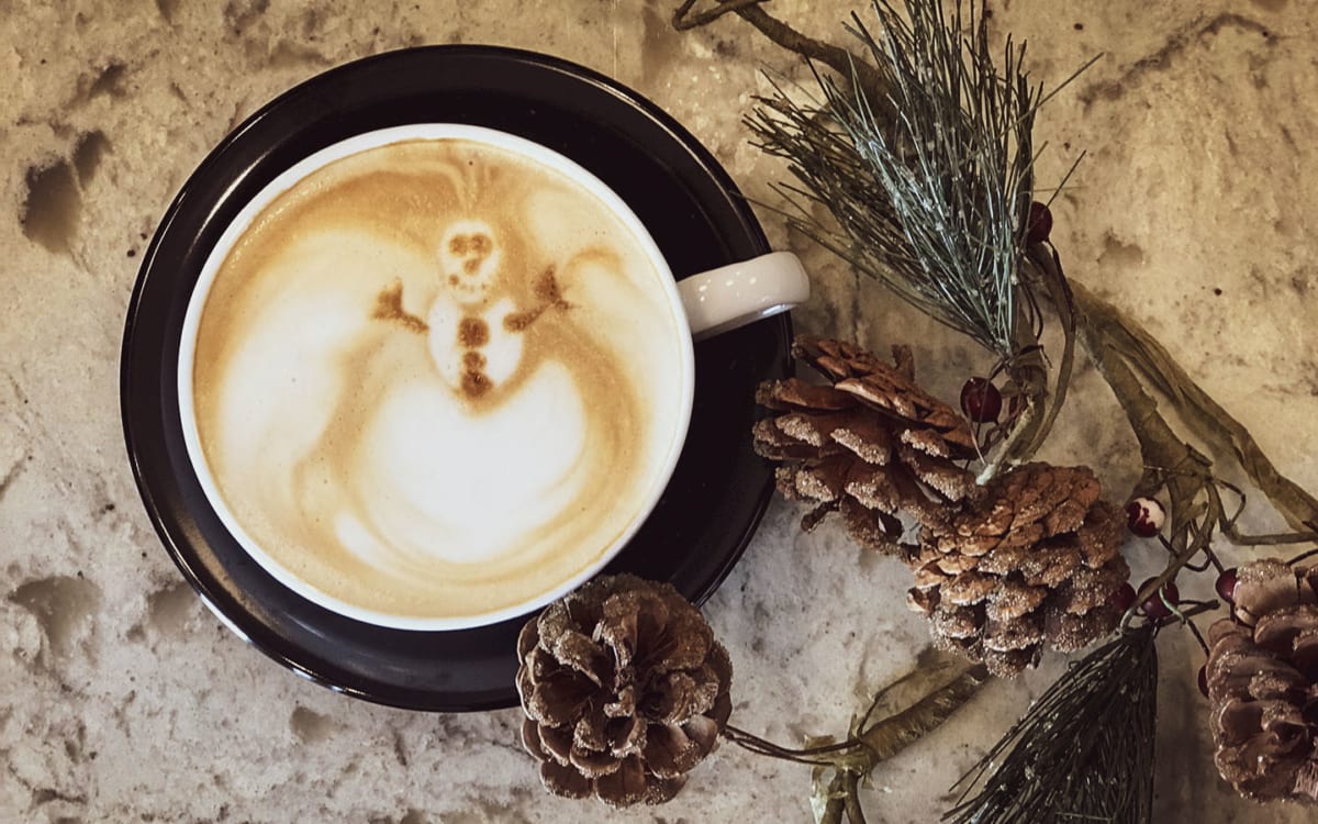 Latte with snowman foam art.