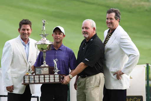 Pro golfer, John Pillar, holding Professionals Tournament trophy.