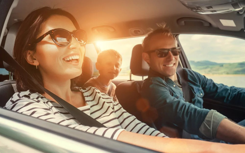 Family driving and smiling.