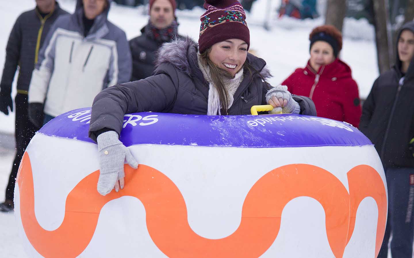 Woman in snow bumper inflatable.