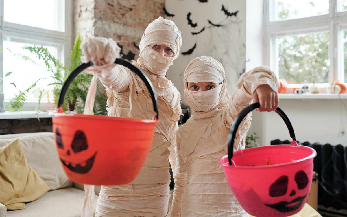 Mummies with Halloween treat baskets.