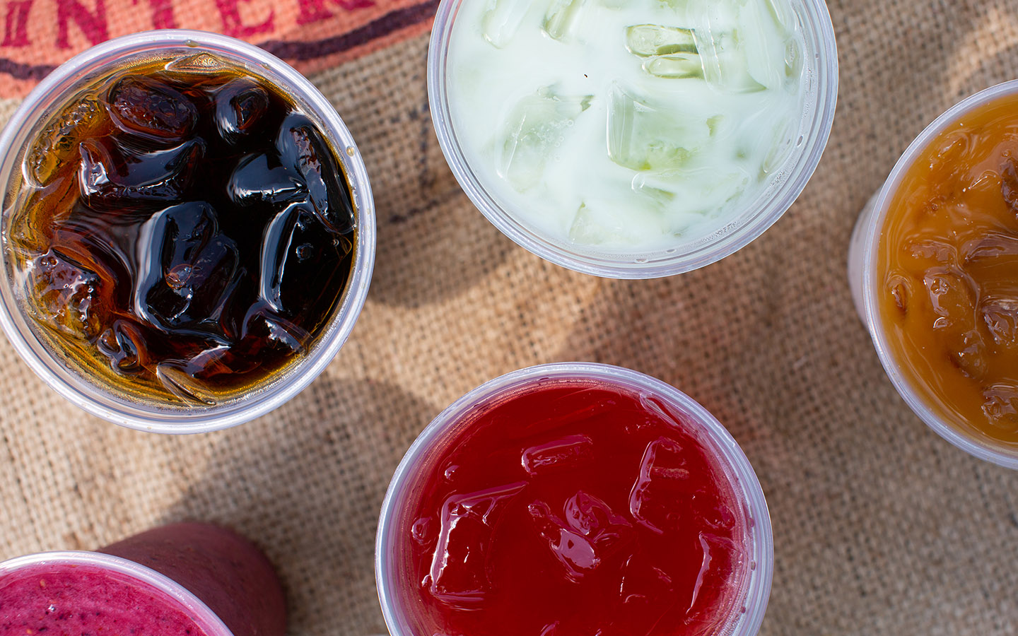 Overhead close up of several iced drinks.