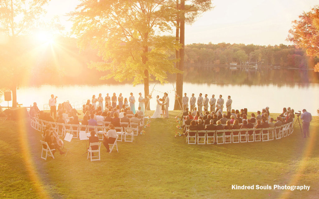 Lakeside wedding ceremony at sunrise.