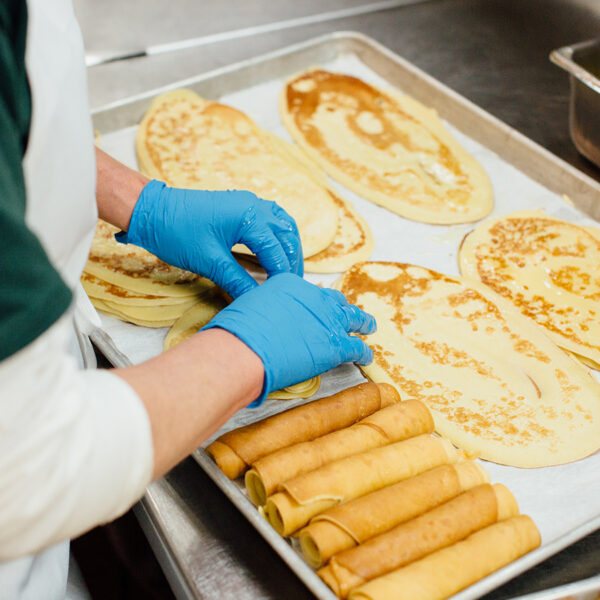 Chef rolling pancakes.