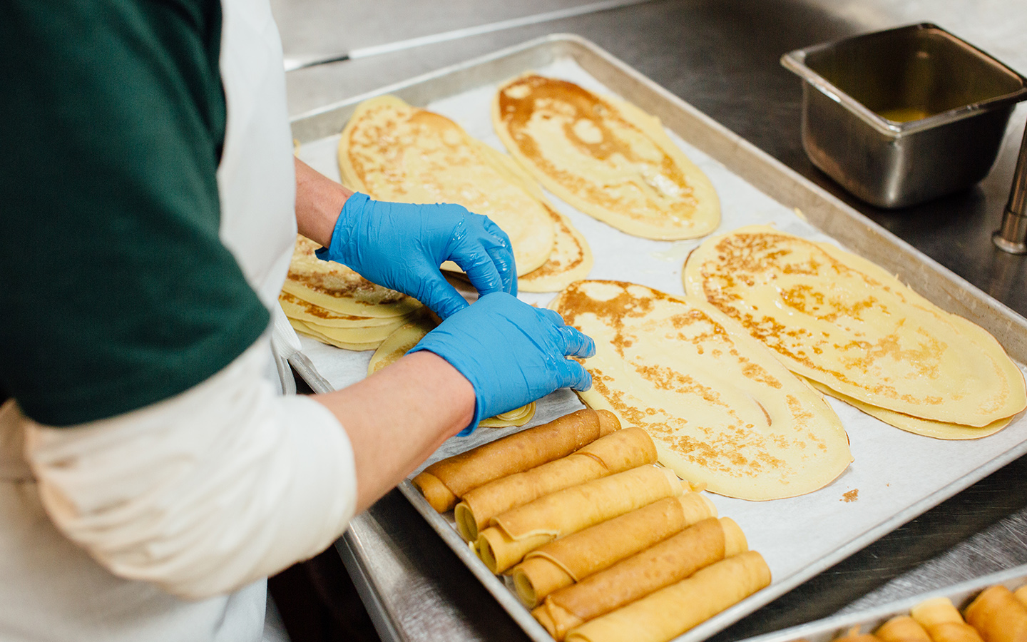 Chef rolling pancakes.