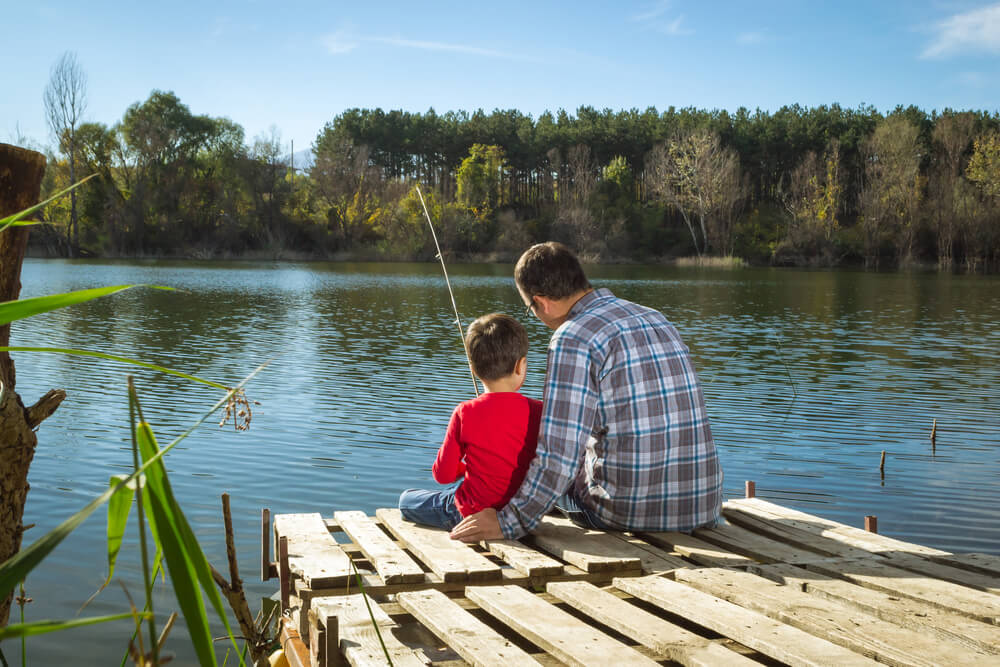 Photo of father and son enjoying a day of Poconos fishing at Woodloch