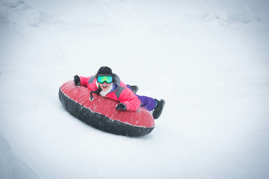 Photo of a person snow tubing in the poconos at Woodloch