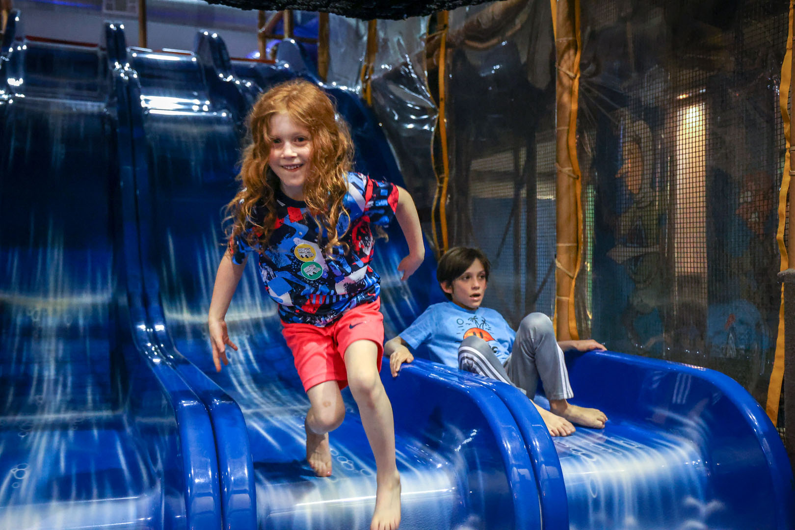 Young girl in a playground tunnel.