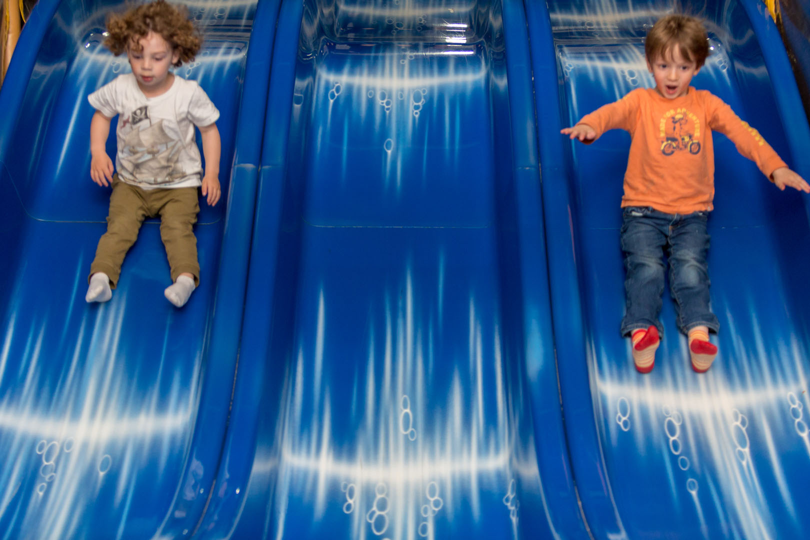 Young girl at the bottom of a slide.