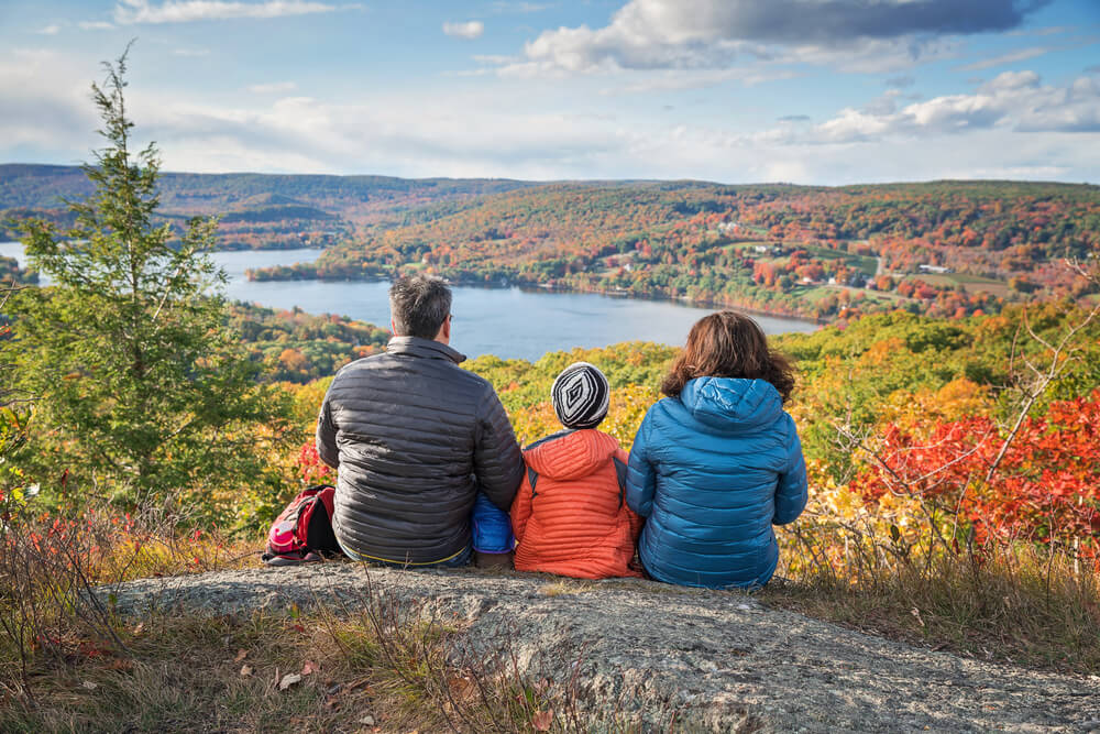 Photo of family sitting admiring view of the Poconos fall foliage