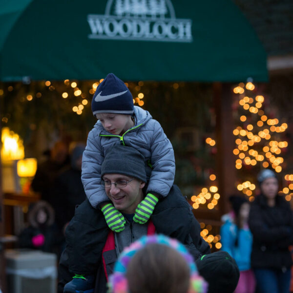 Photo of kid on parents shoulder at Woodloch during a family holiday getaway