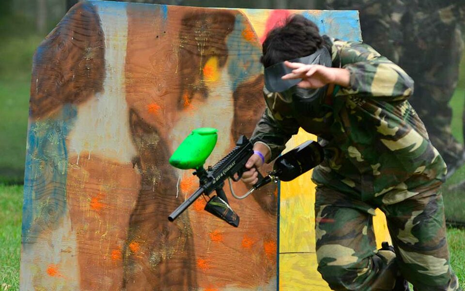 Paintball player in camoflage running.