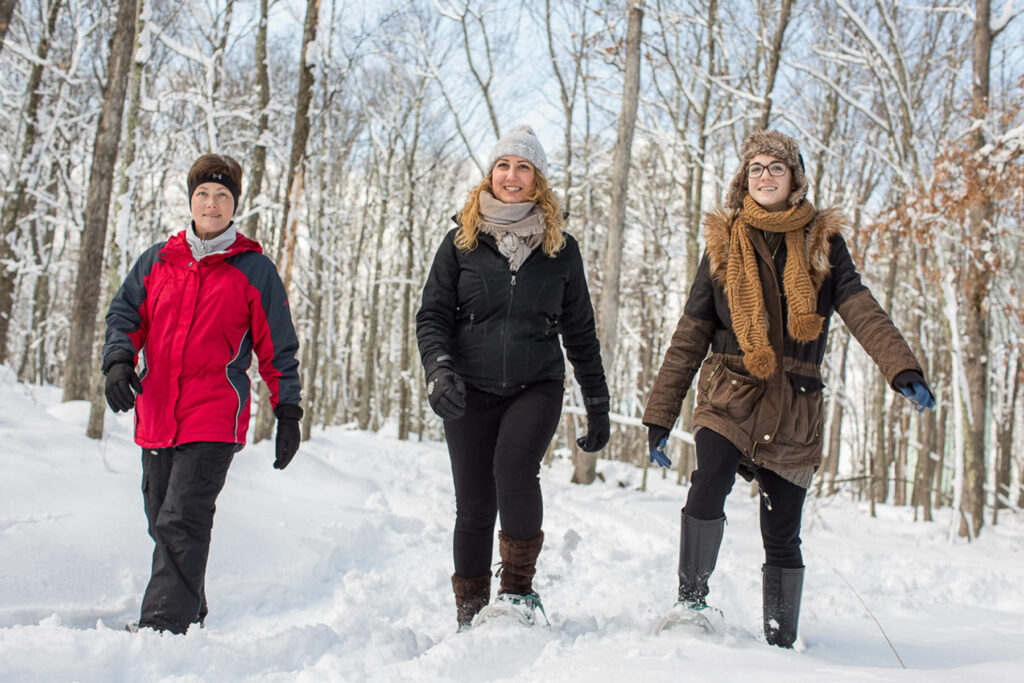 A group snowshoeing, one of the top winter activities in the Poconos.