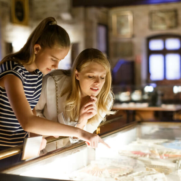 Two people looking at exhibits in one of the Pennsylvania museums in the Poconos.