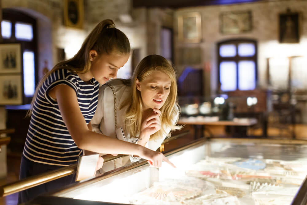 Two people looking at exhibits in one of the Pennsylvania museums in the Poconos.