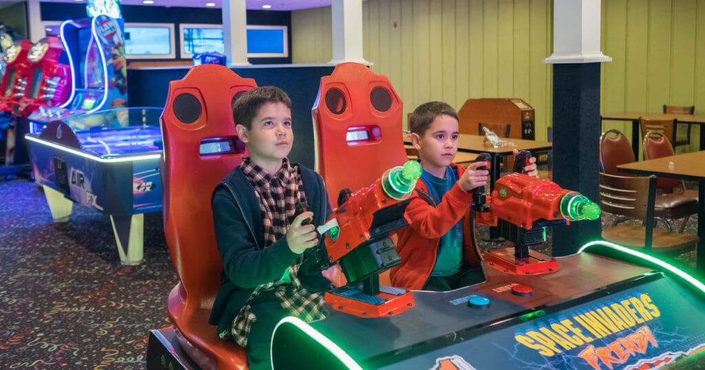 Kids playing in the arcade, one of the best indoor activities in the Poconos.