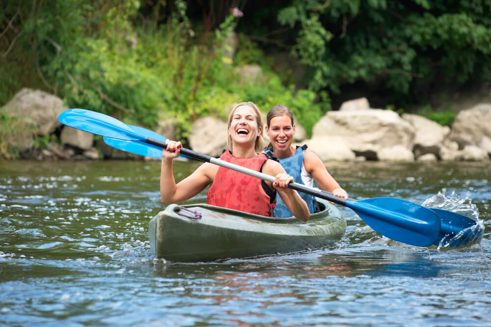 Two women kayaking in the Poconos.