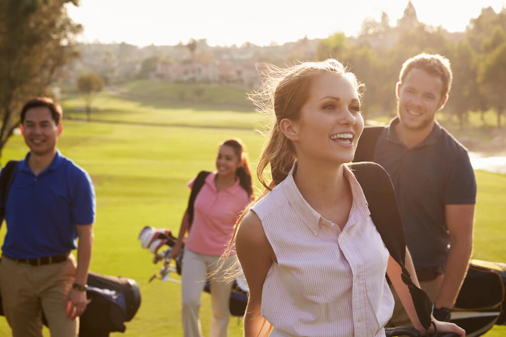 A group of people golfing, one of the best things to do in the Poconos for adults.