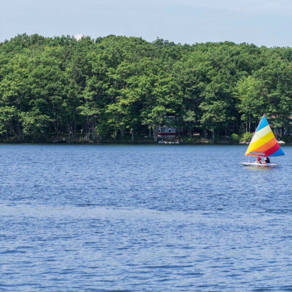 A boat our on the water on a lakefront vacation in the Poconos.