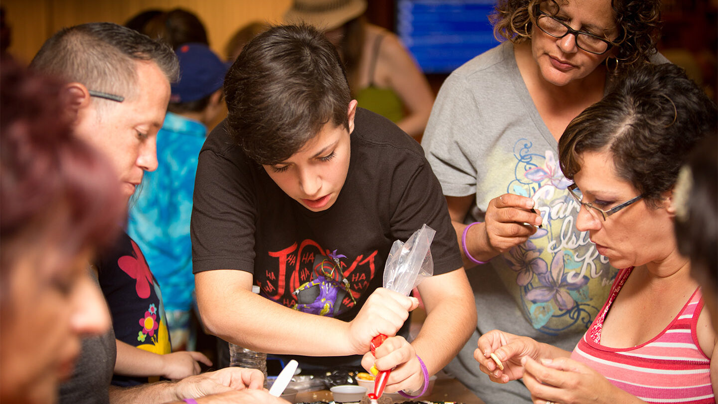 Group decorating a cake.