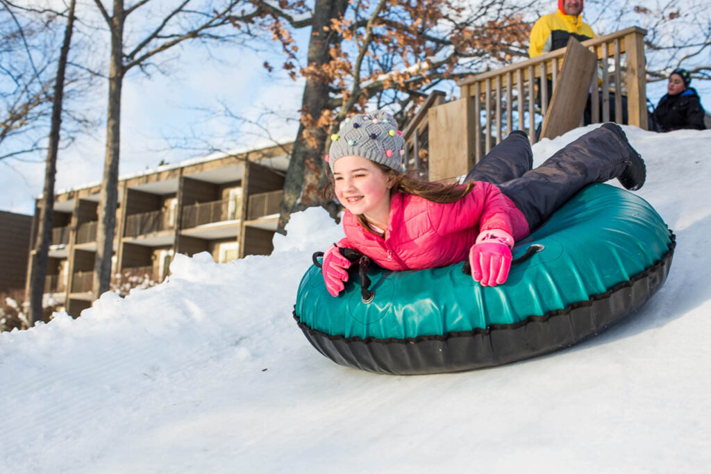 A kid tubing on a Pennsylvania winter vacation to the Poconos.