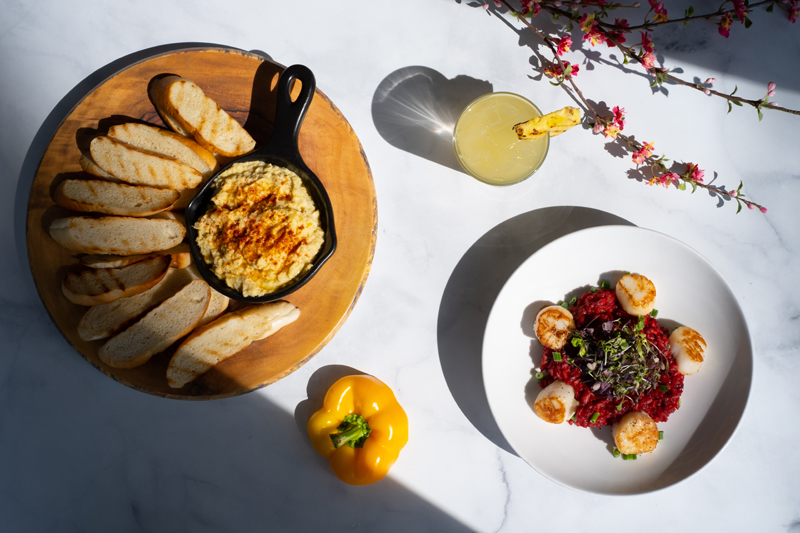 Overhead view of scallops, bread and hummus.