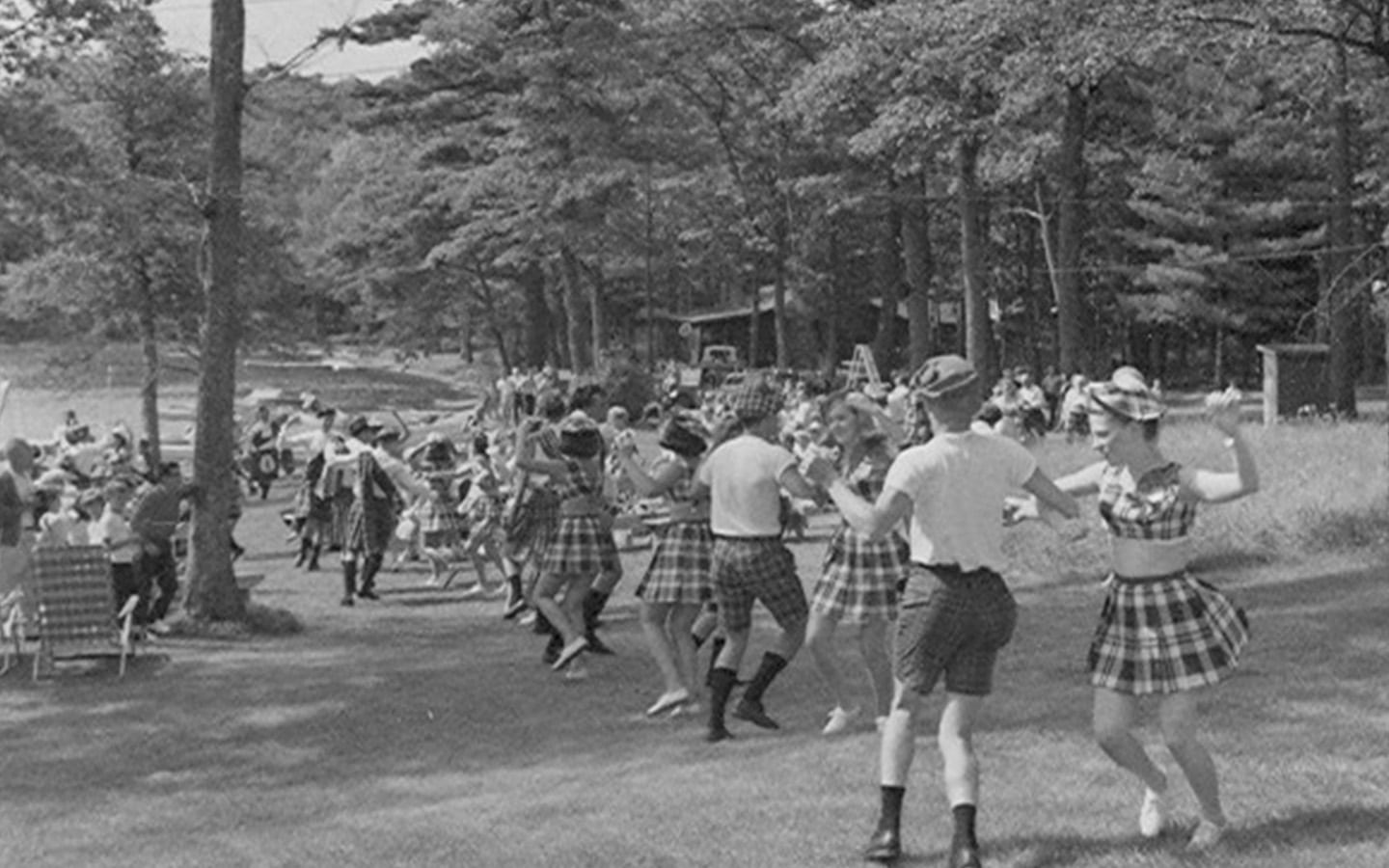 Historic photo of large group doing Scottish dancing